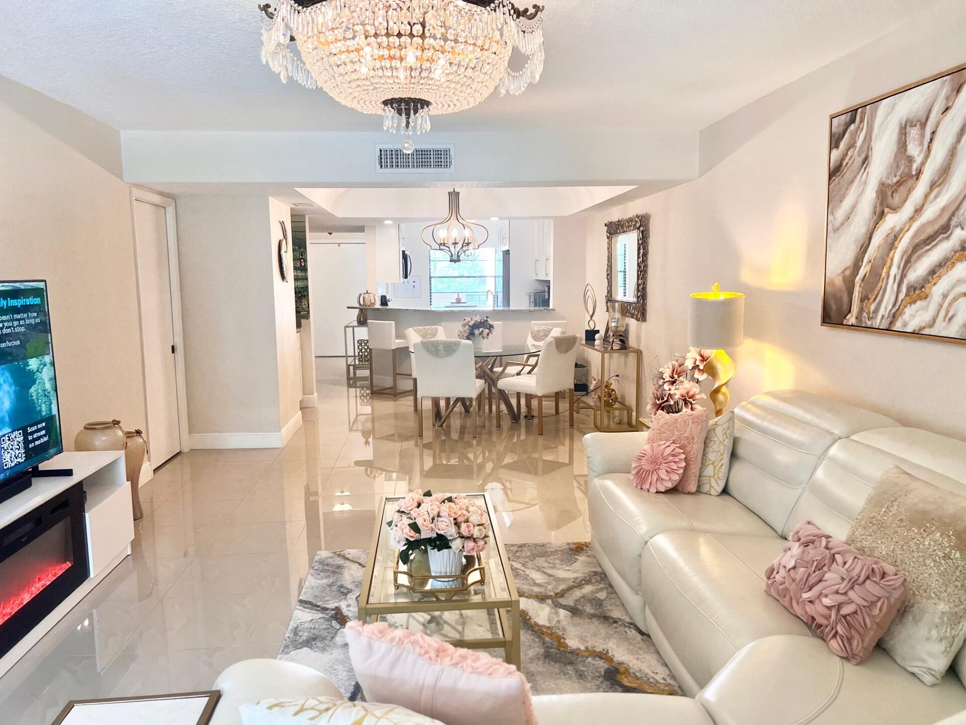 a living room with furniture and a chandelier