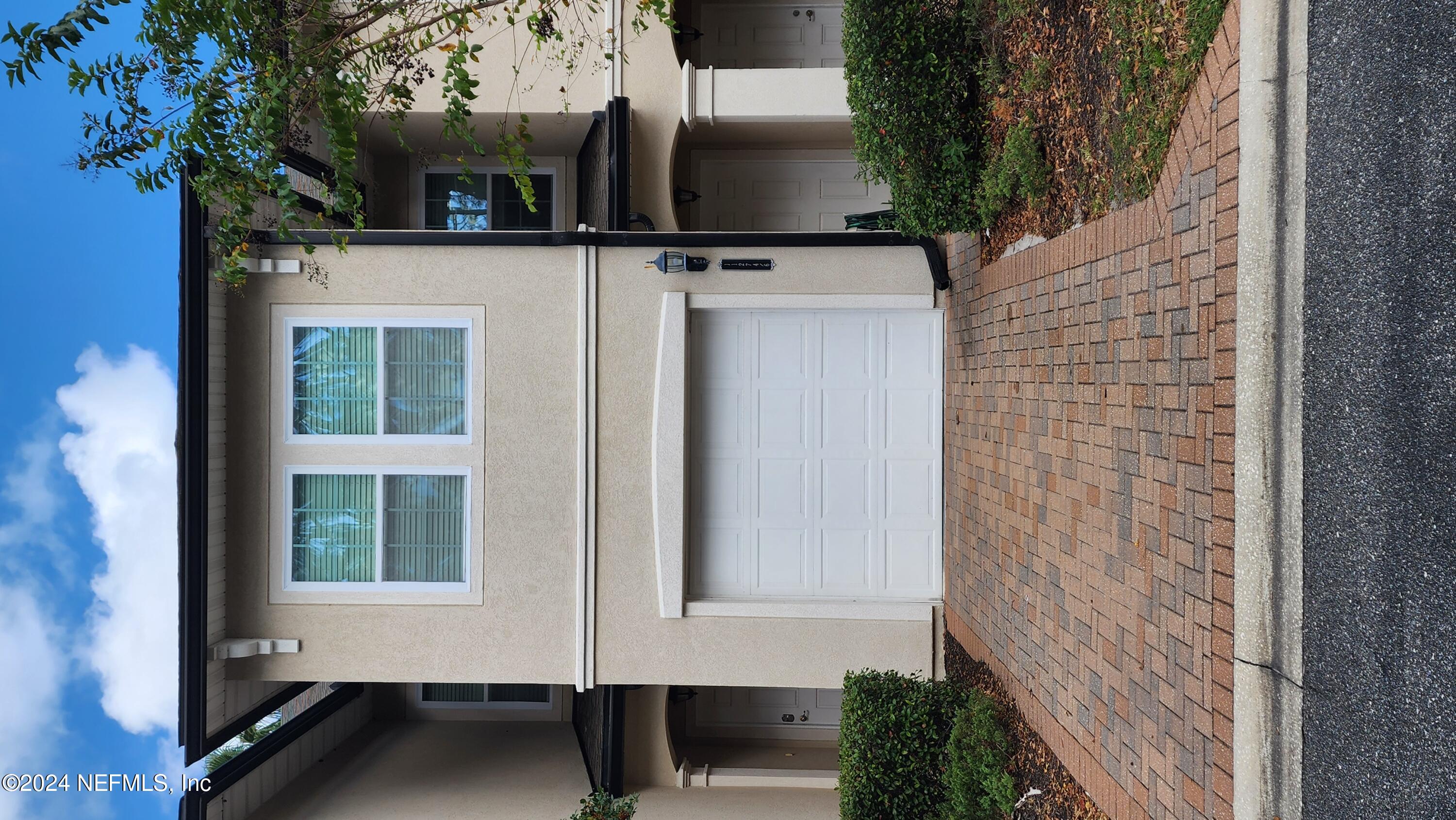 a front view of a house with garage