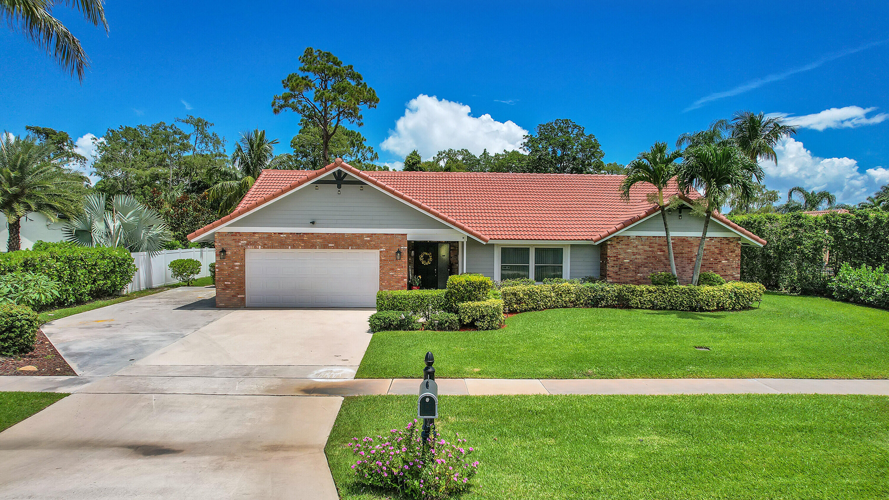 a front view of a house with a garden