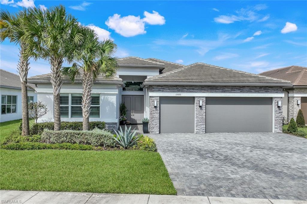 View of front facade with a garage and a front yard