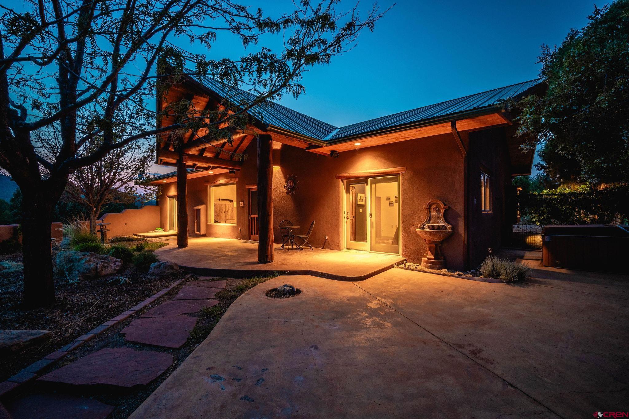 a view of a house with backyard and sitting area