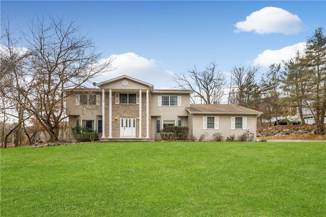 a front view of house with yard and green space