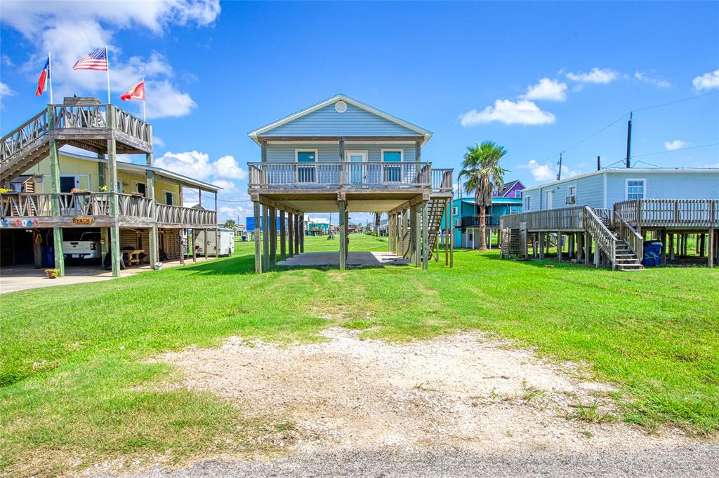 a view of a house with a yard and sitting area