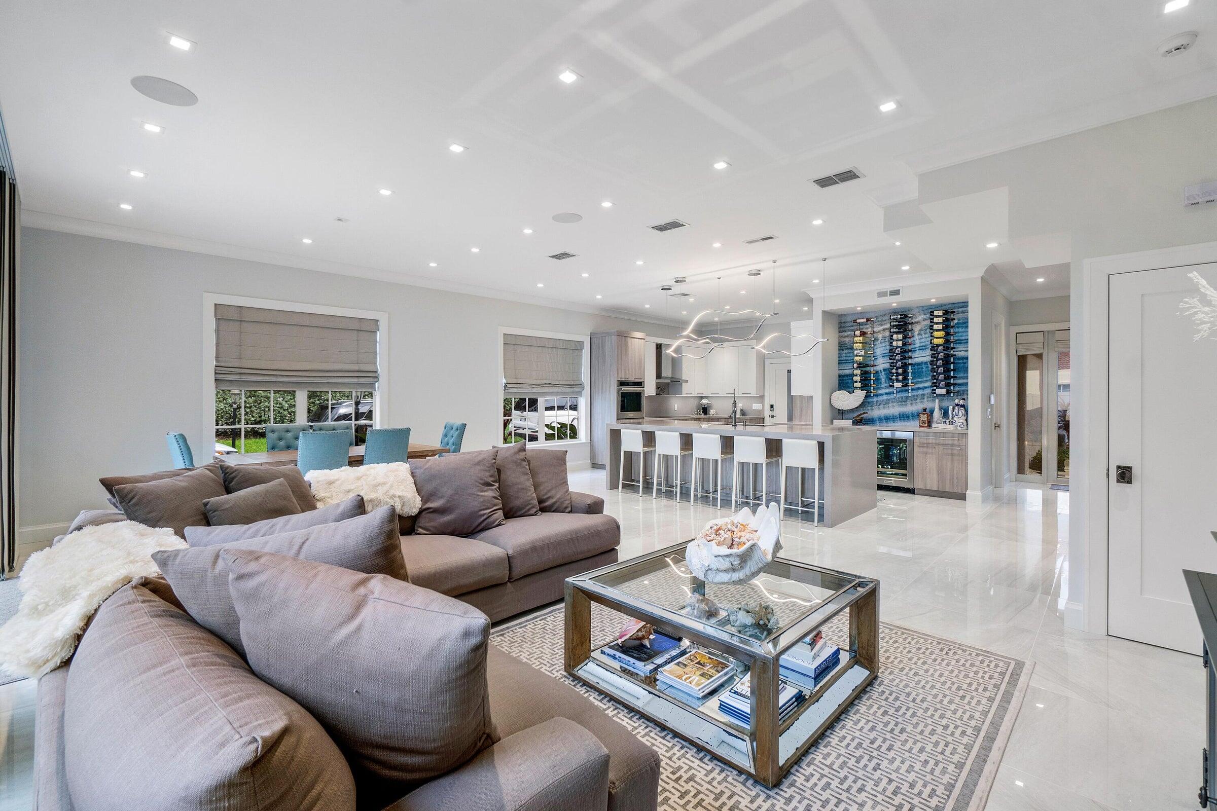 a living room with furniture a table and a kitchen view