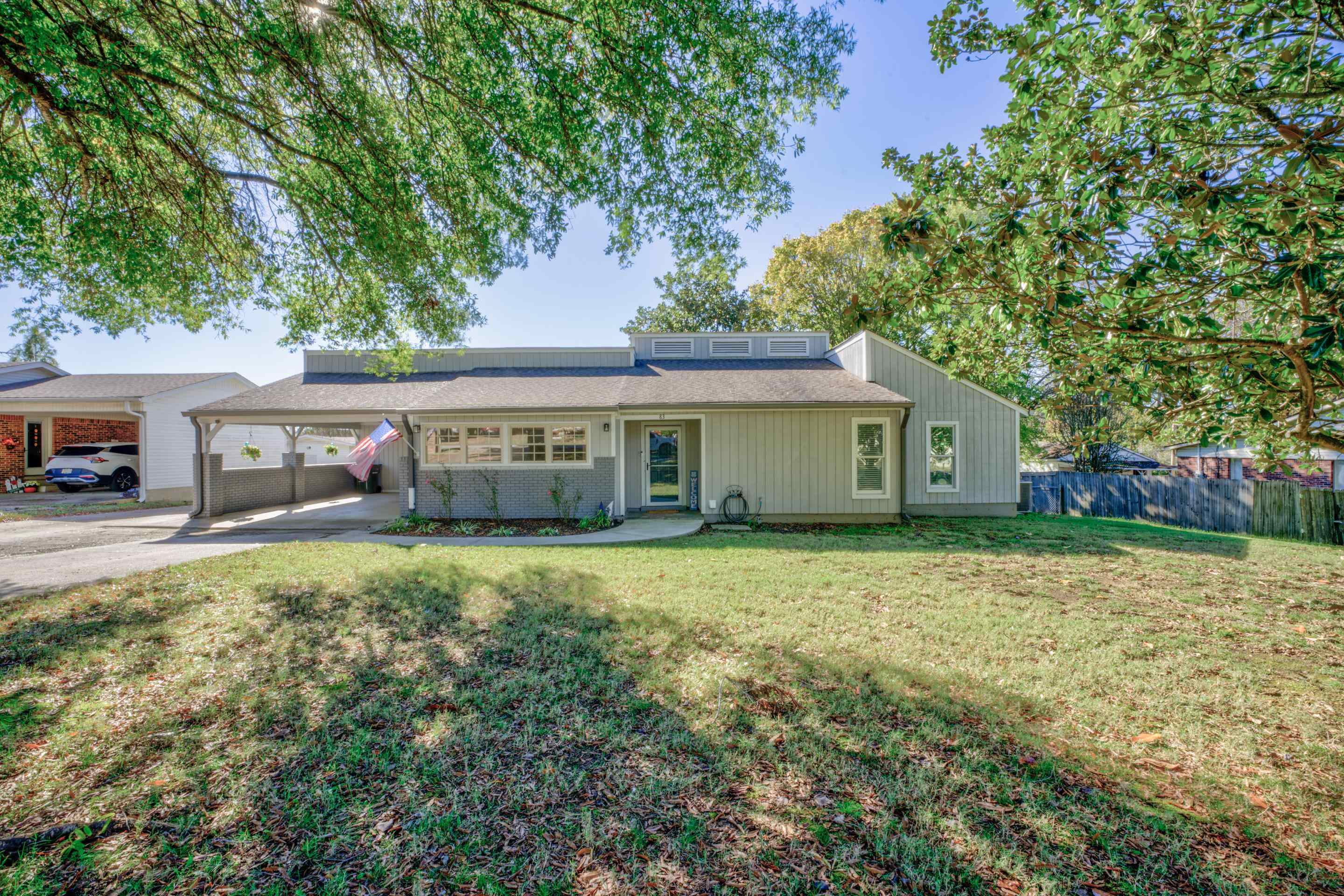 a front view of house with yard and trees