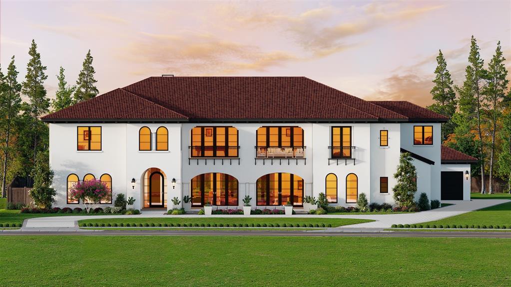 a view of a large white building with many windows and yard