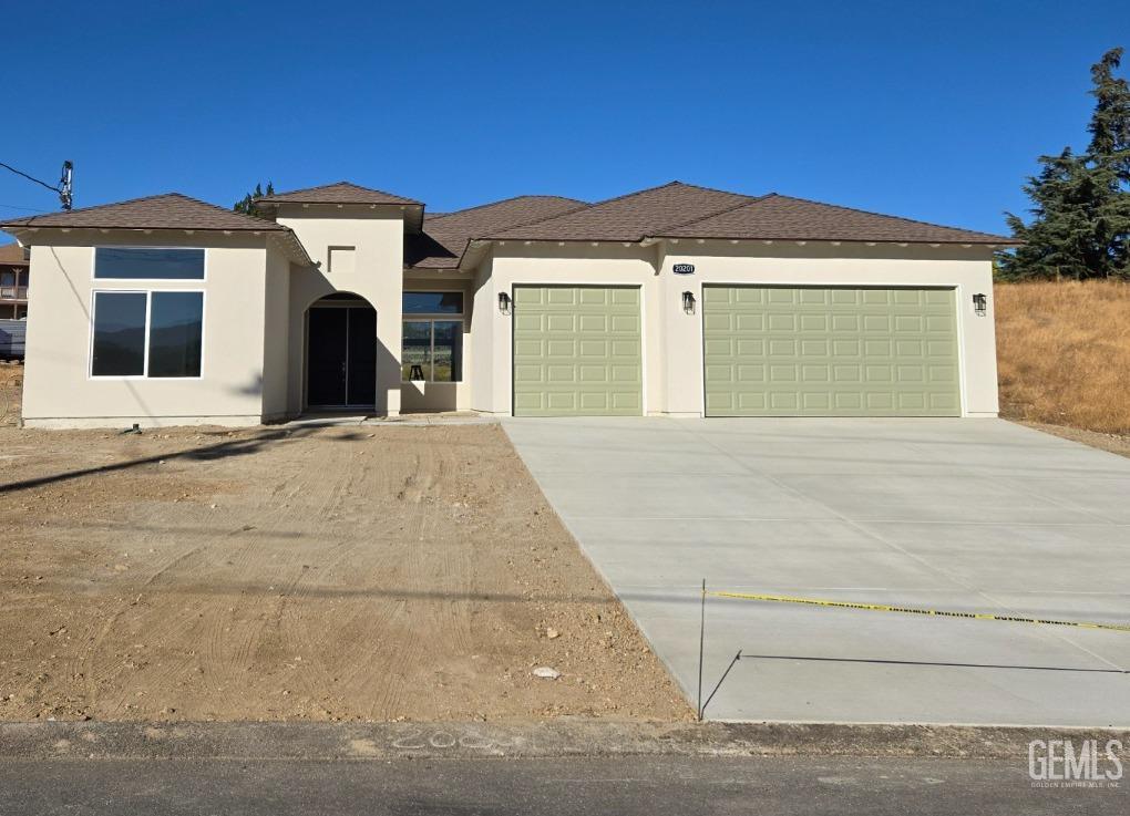 a view of a house with a small space and a car parked in front of it