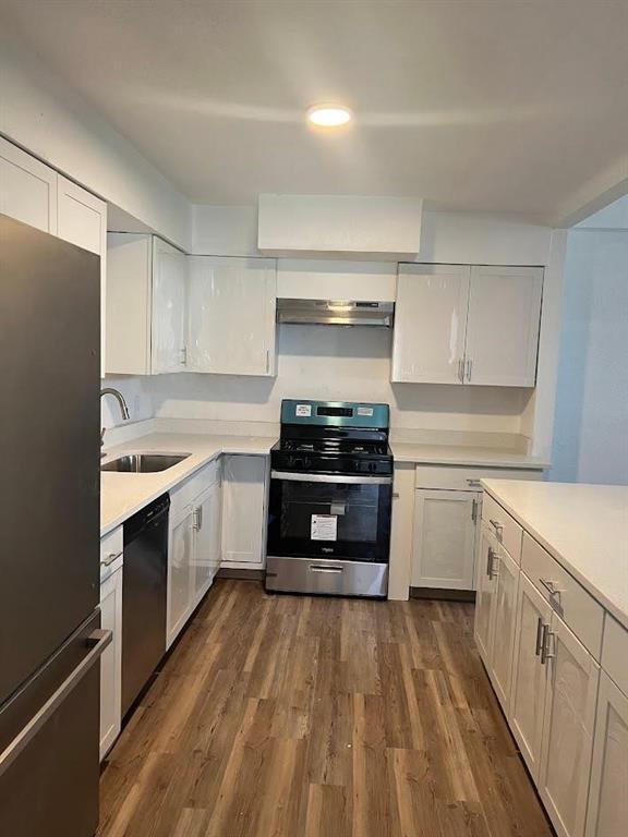 a kitchen with a white stove top oven and cabinets