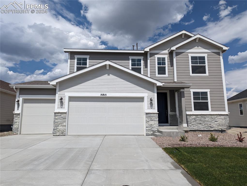 a front view of a house with a yard and garage