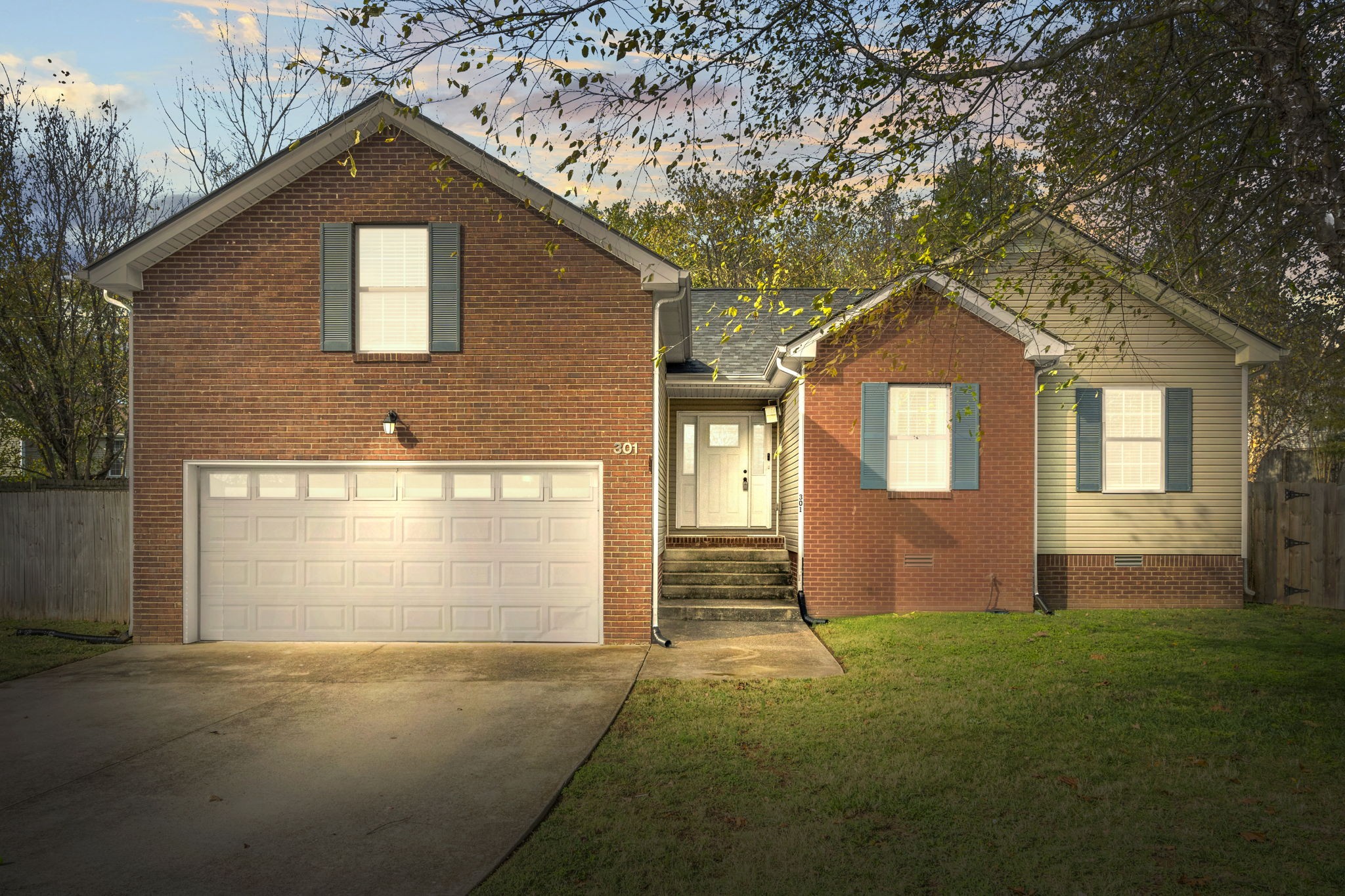 a front view of a house with a garden and garage