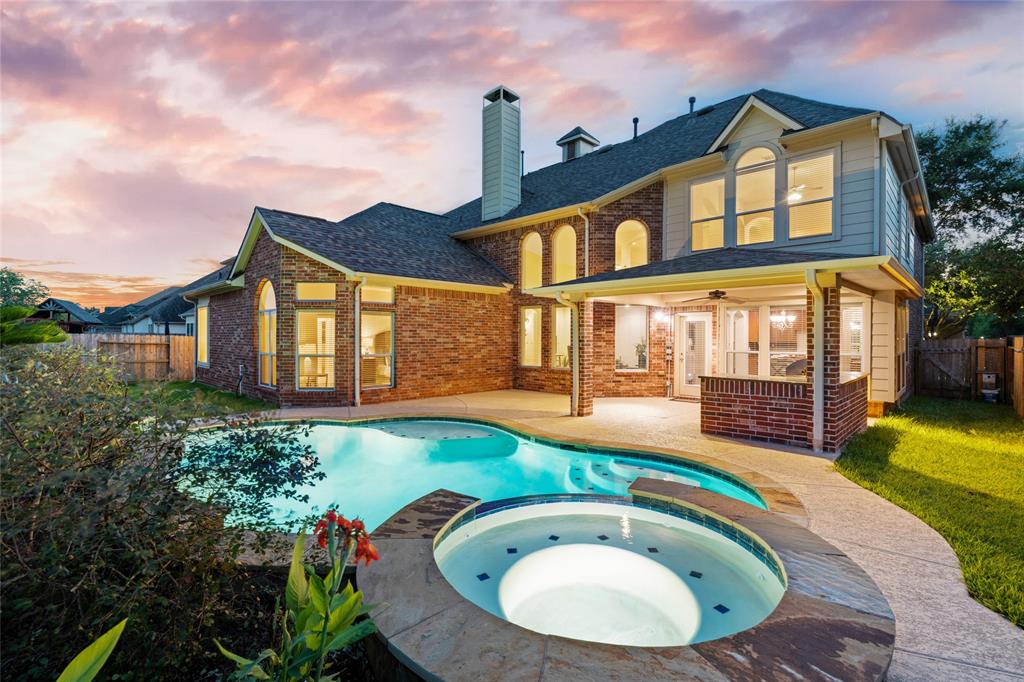 a view of a house with swimming pool and porch