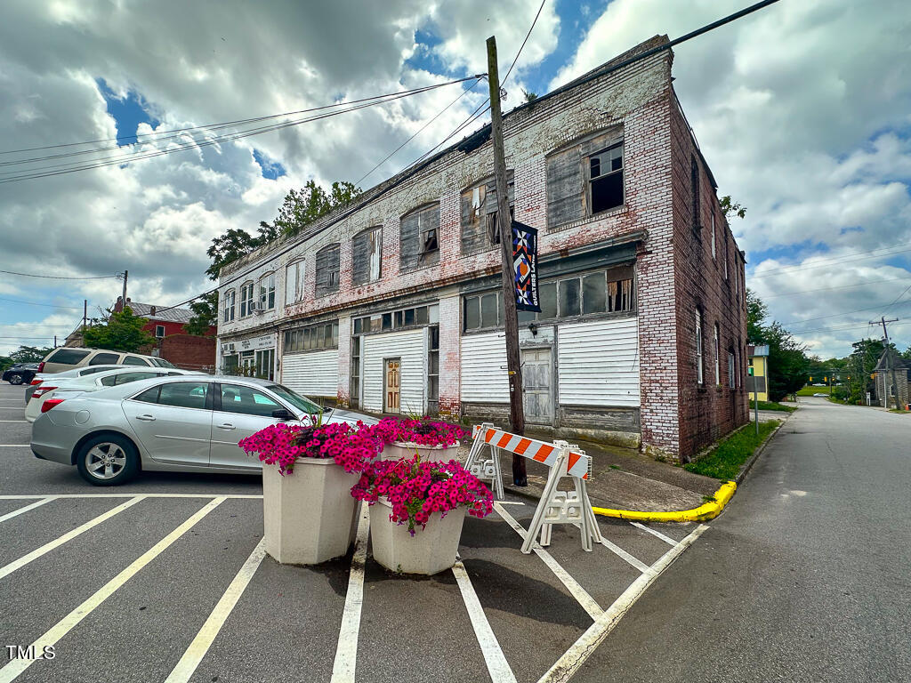 a view of a cars park in front of a building