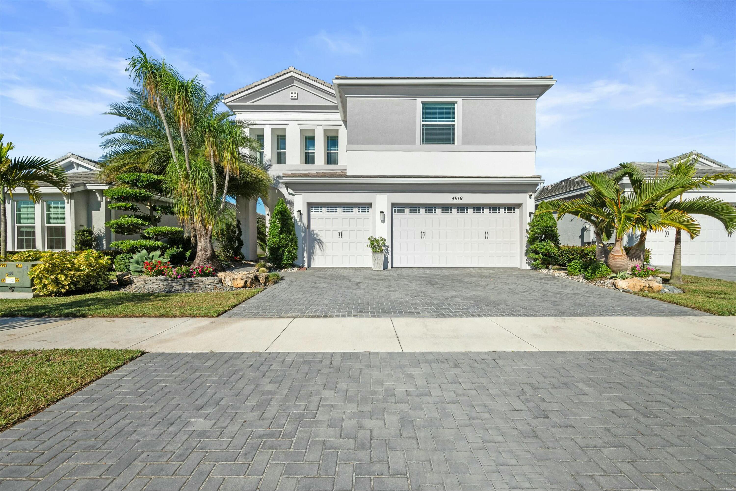 a front view of a house with a yard and a garage