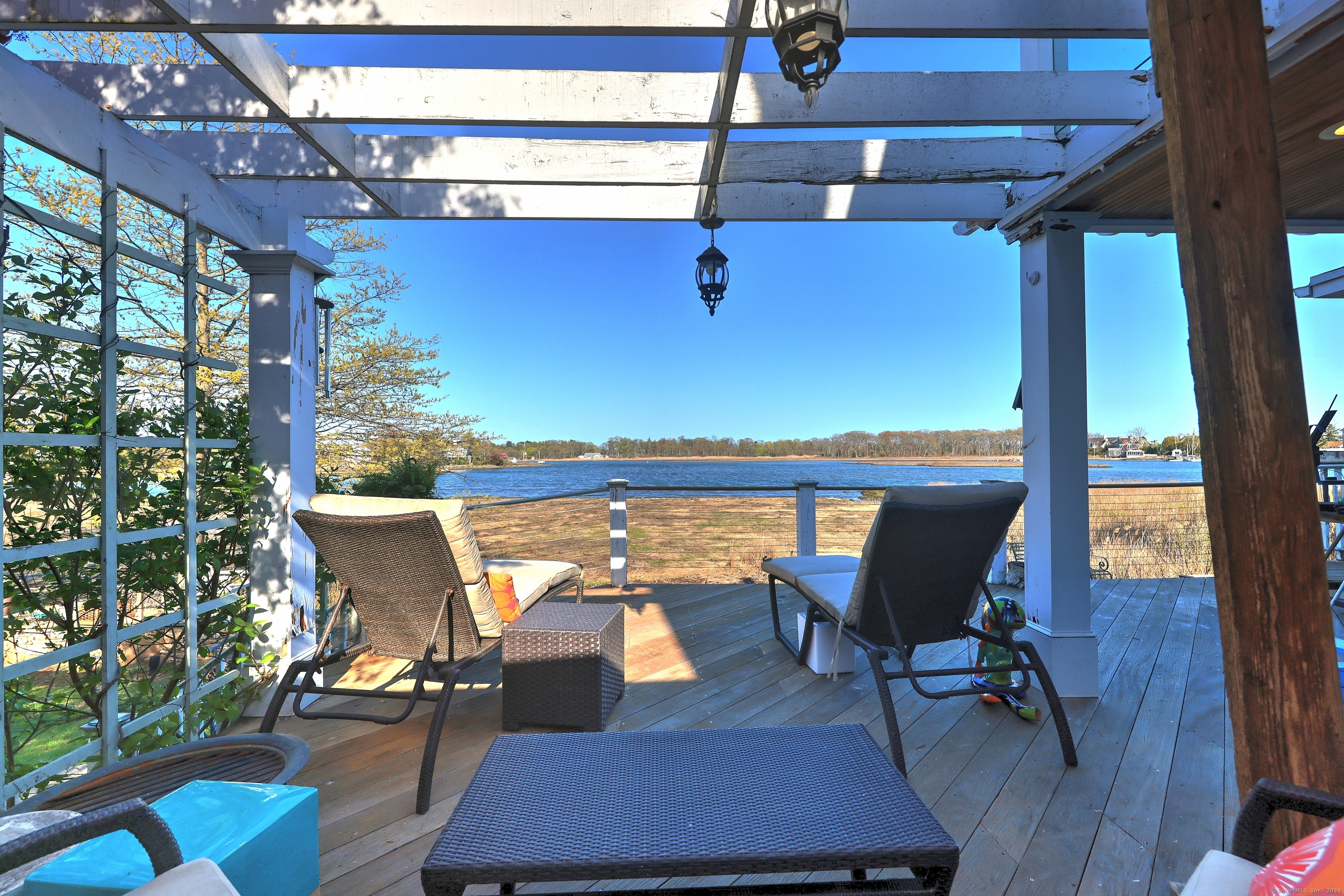 a view of a balcony with chairs and wooden floor