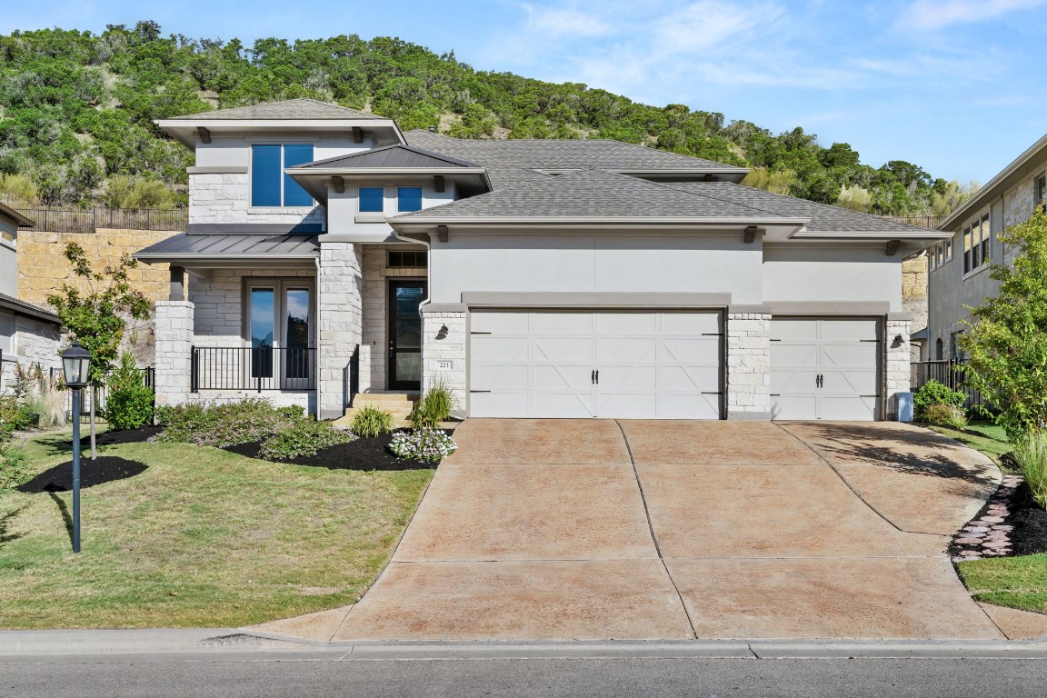 a front view of a house with a yard and garage