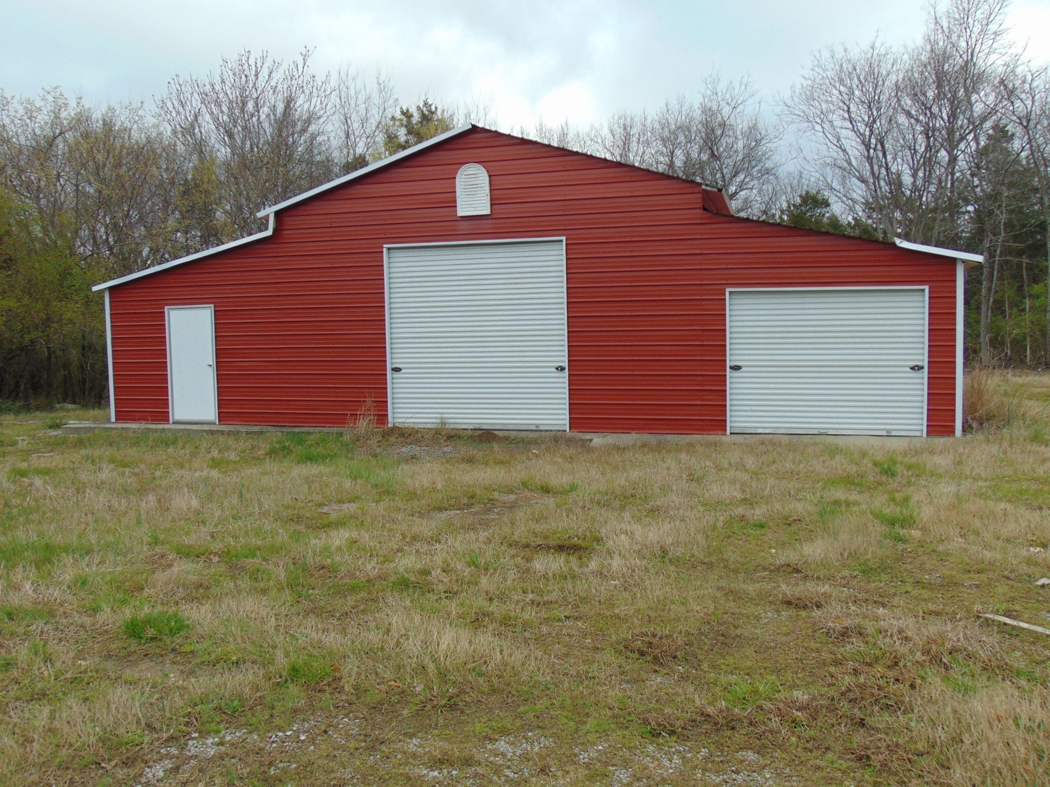 a front view of house with yard and trees