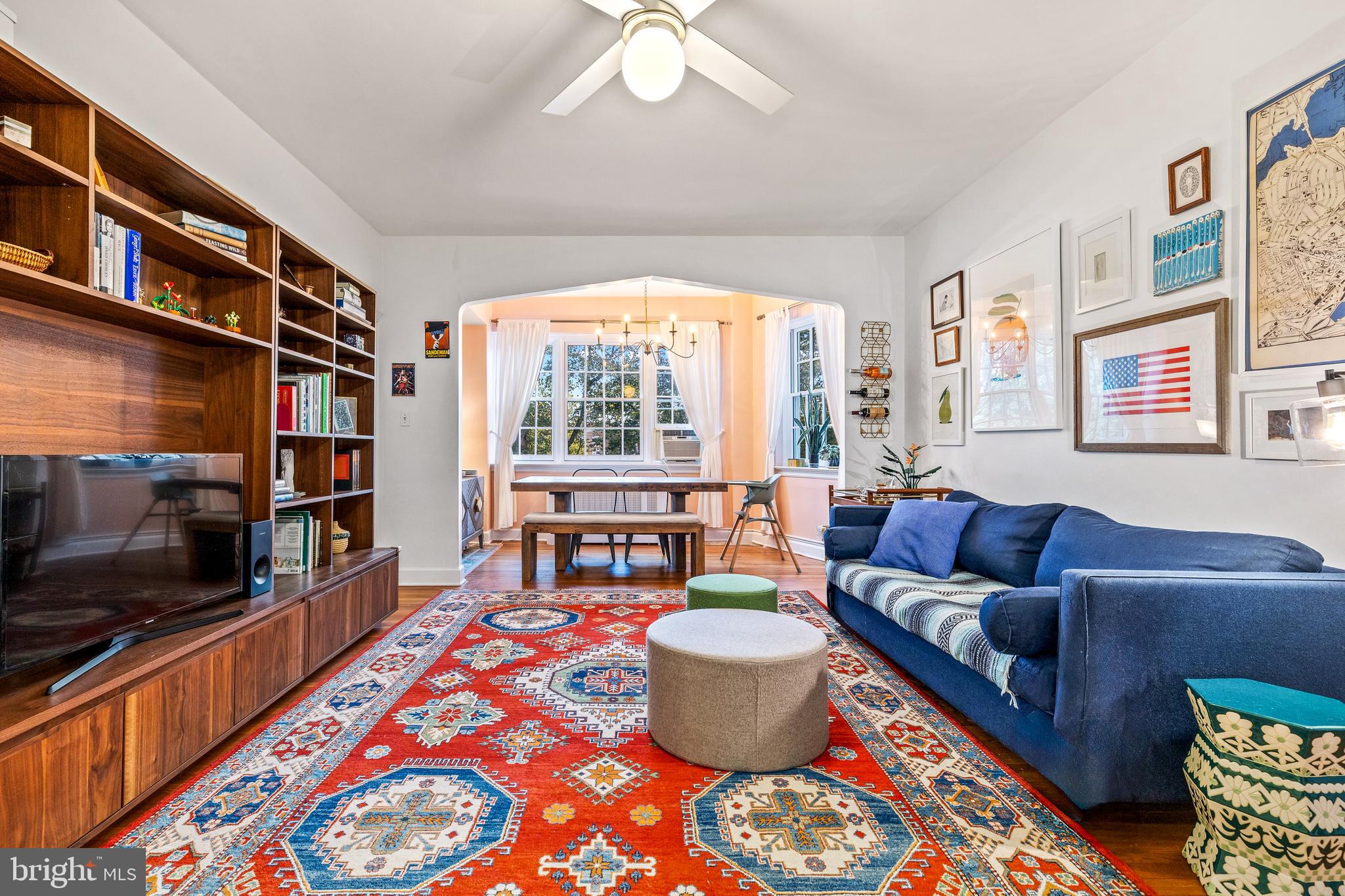 a living room with furniture a flat screen tv and a rug