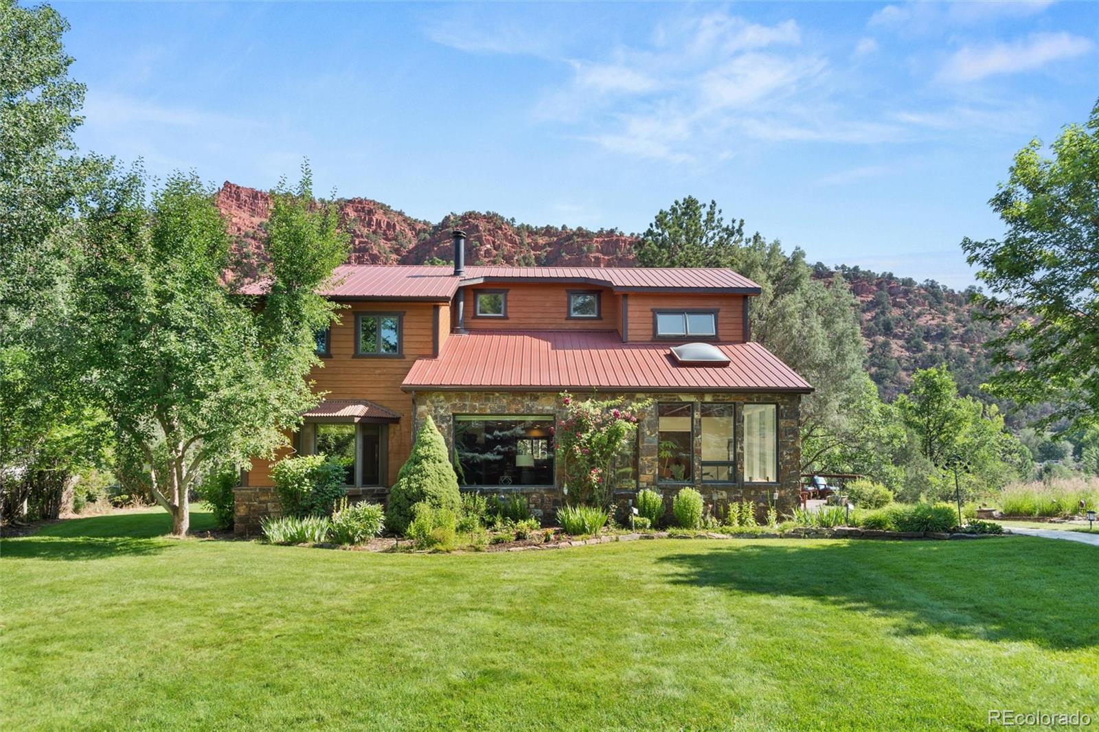 a front view of a house with a garden