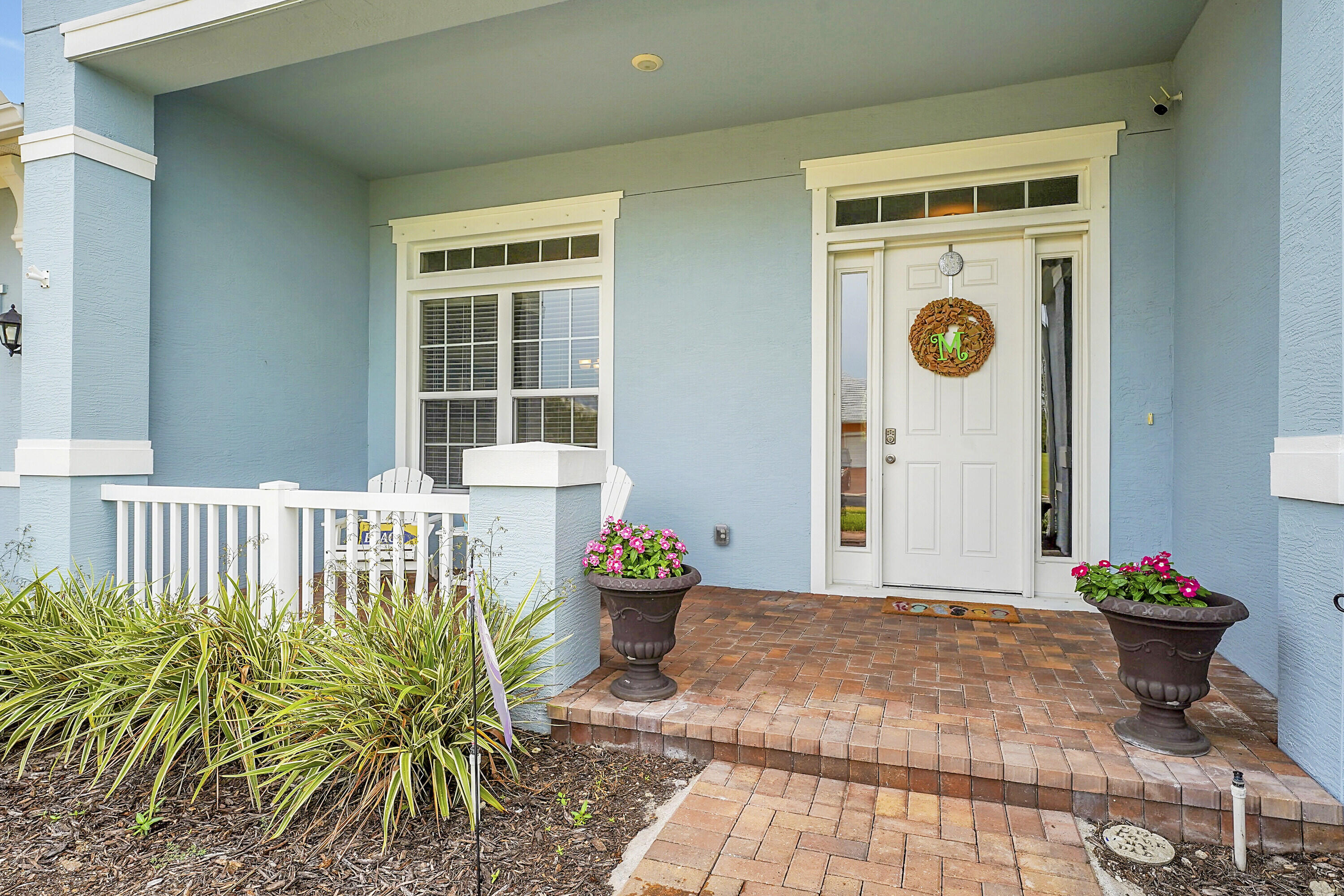 a front view of a house with outdoor seating