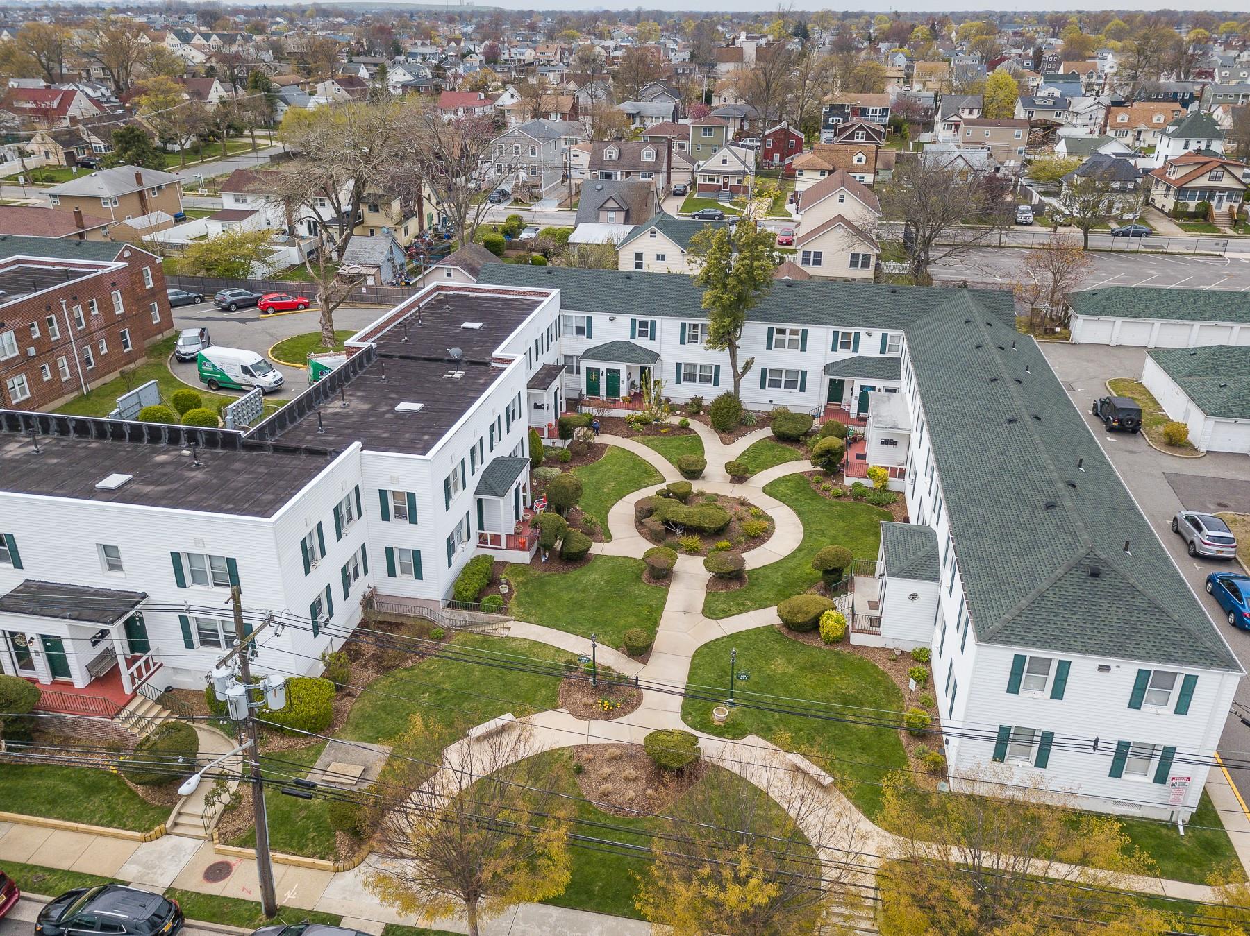 an aerial view of residential houses with outdoor space