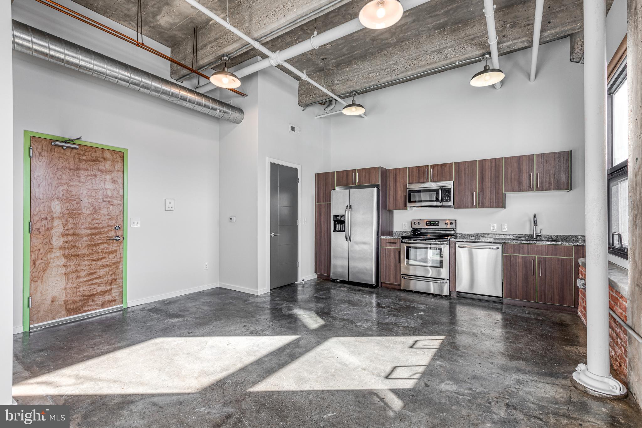 a large kitchen with cabinets and stainless steel appliances