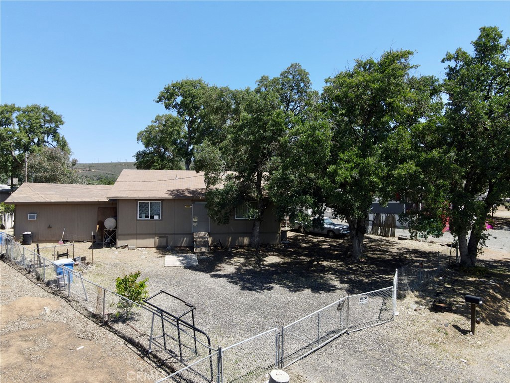 a view of backyard with outdoor seating and trees