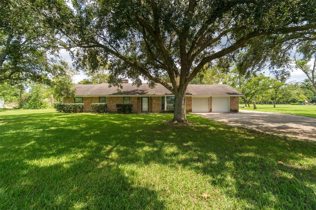 a front view of a house with yard and green space