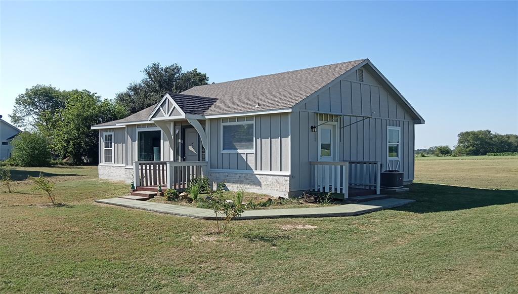 a view of a house with backyard porch and furniture