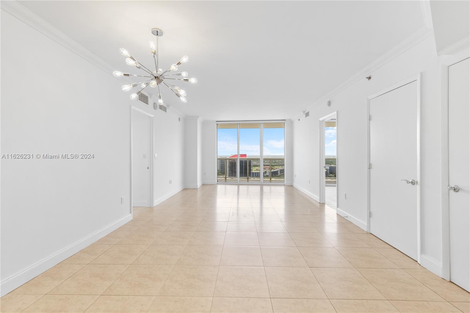 a view of an empty room with a kitchen