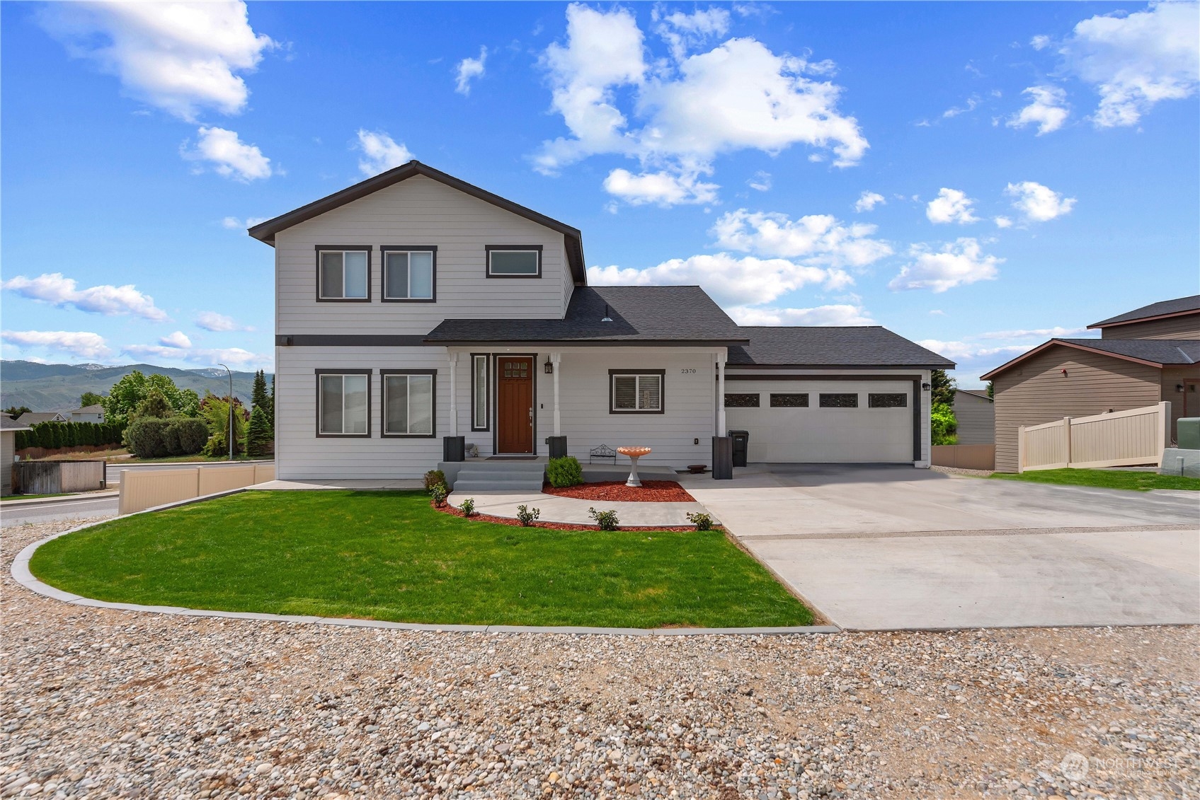 a front view of a house with a garden and yard