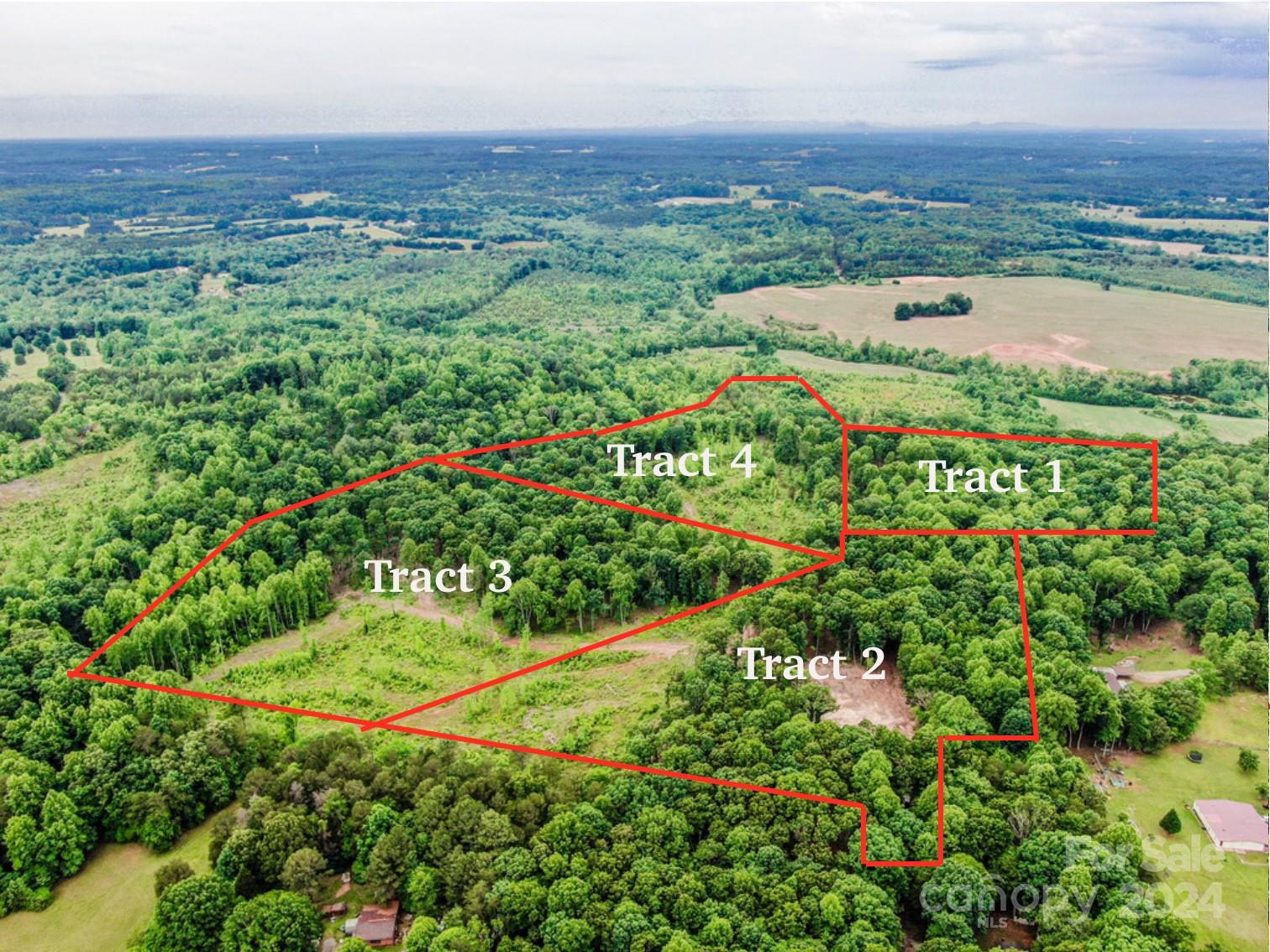 an aerial view of a house with a yard and lake view