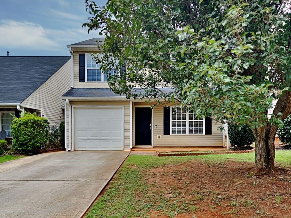 a front view of a house with garden