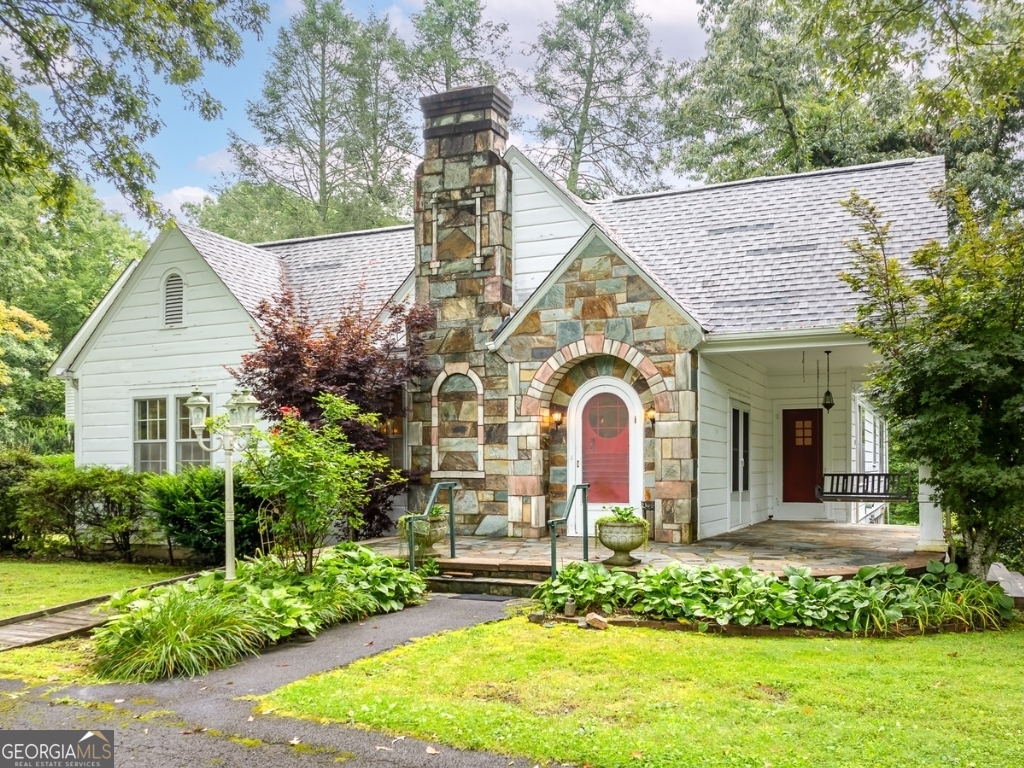 a front view of a house with a garden