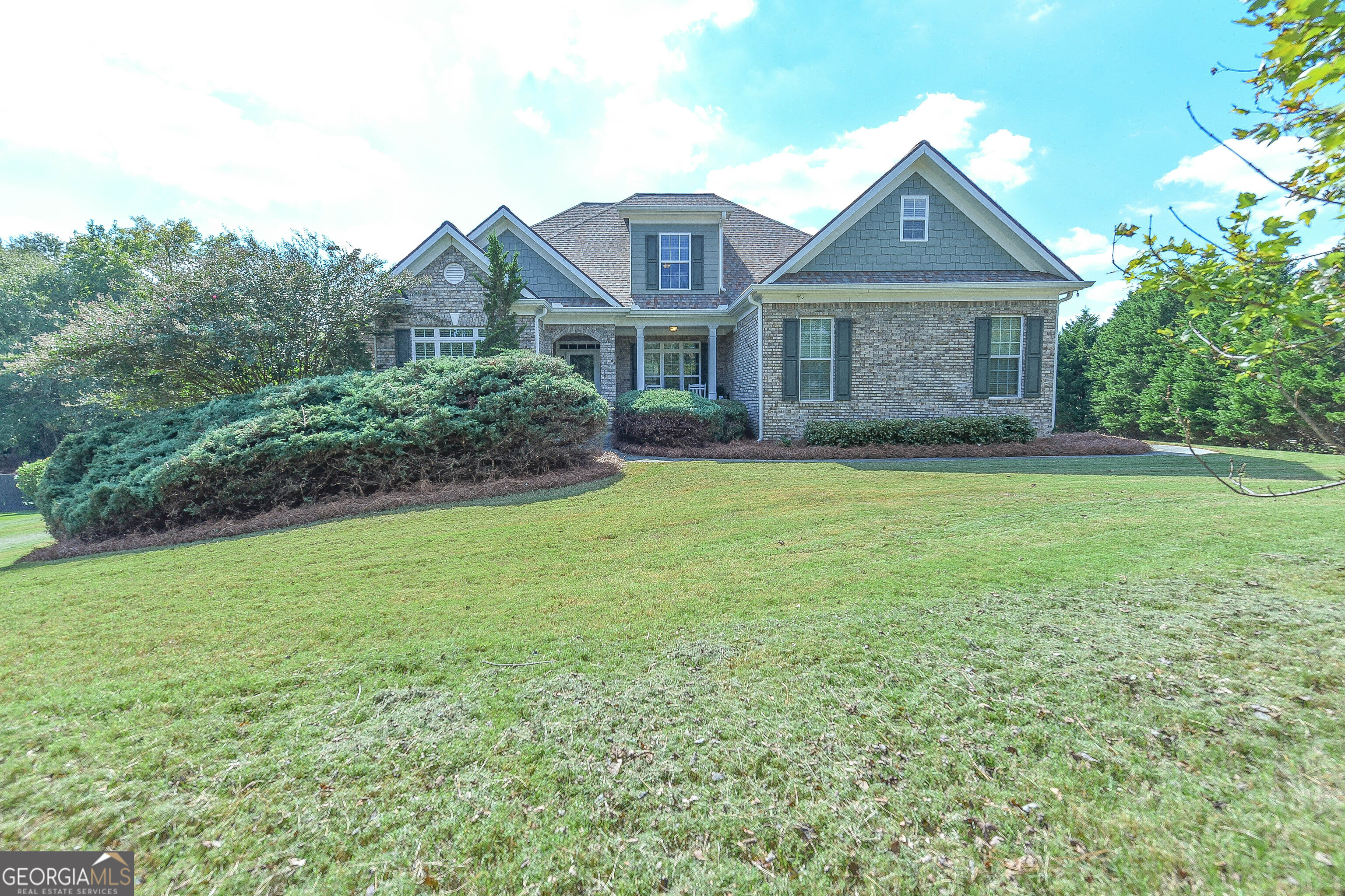 a front view of a house with a yard