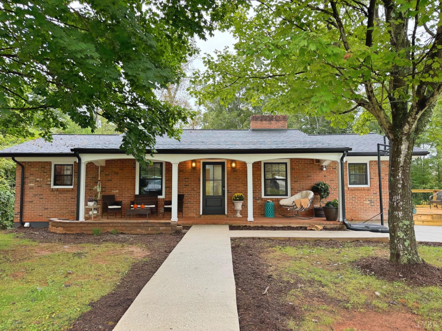 a front view of a house with yard patio and fire pit