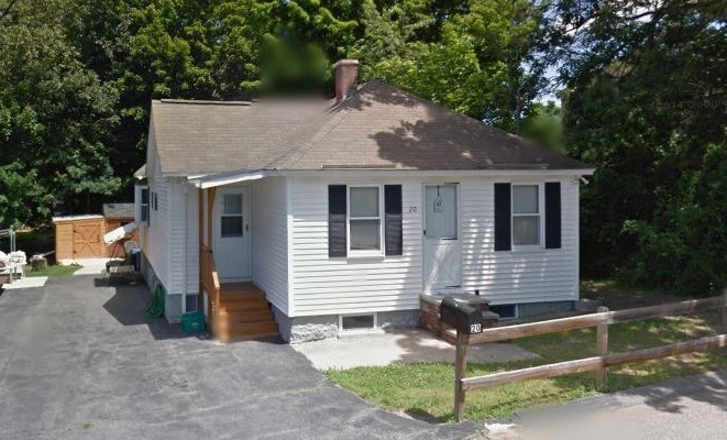 a view of a house with backyard and sitting area