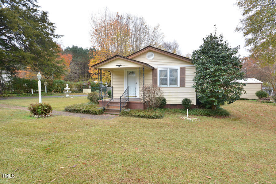 a view of a house with backyard and sitting area