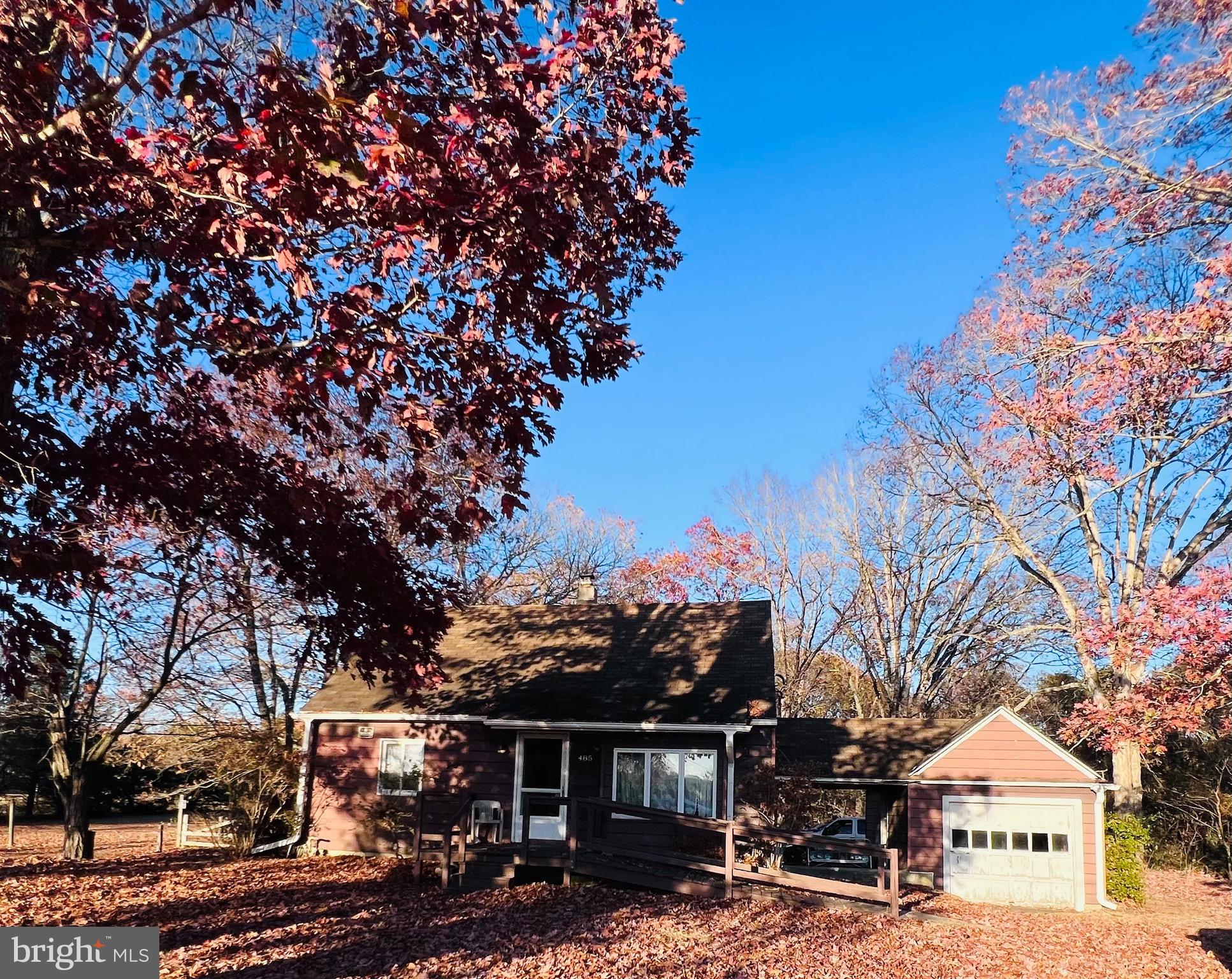 a view of a house with a tree in the background