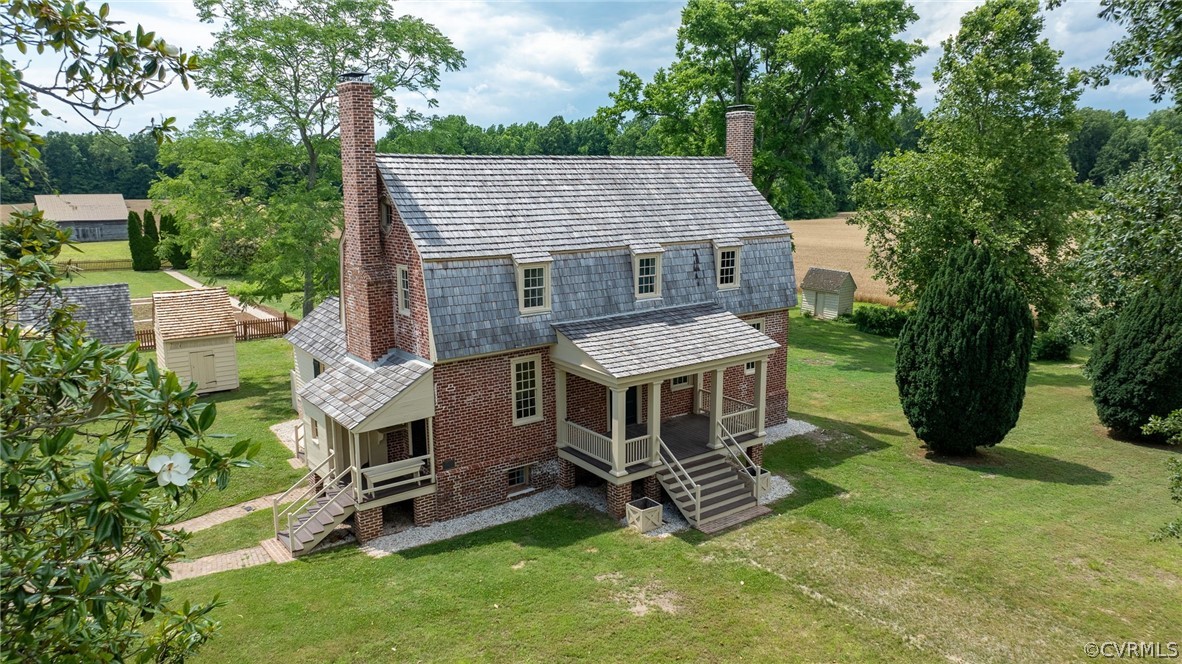 an aerial view of a house with a yard balcony