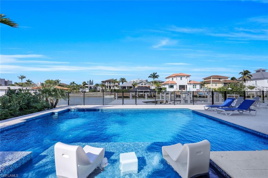 View of swimming pool featuring a water view and a patio area