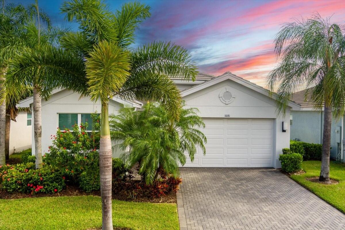 a view of a house with a yard and plant