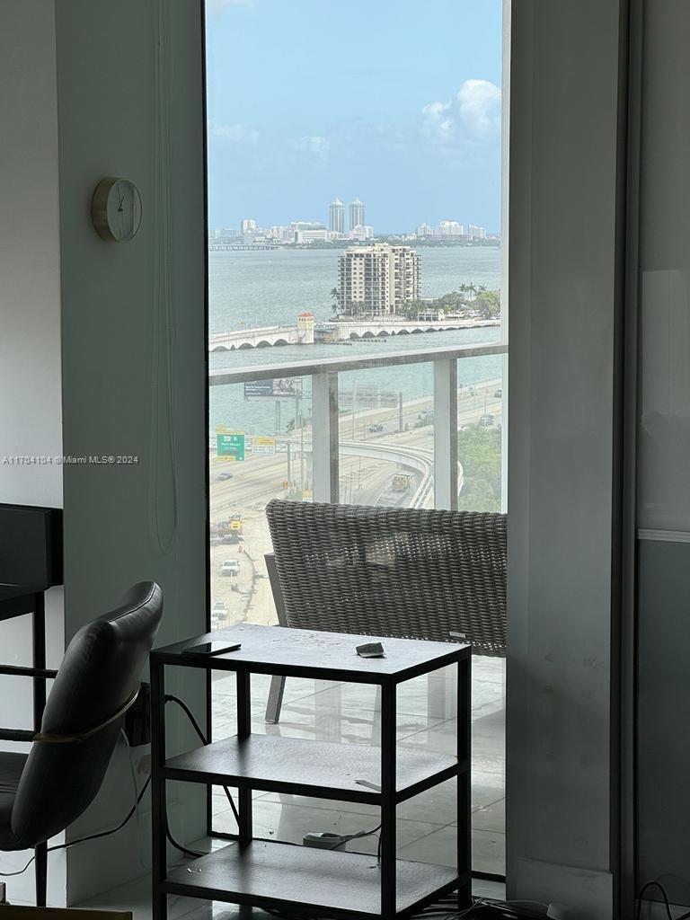 a view of a chairs and table in the balcony