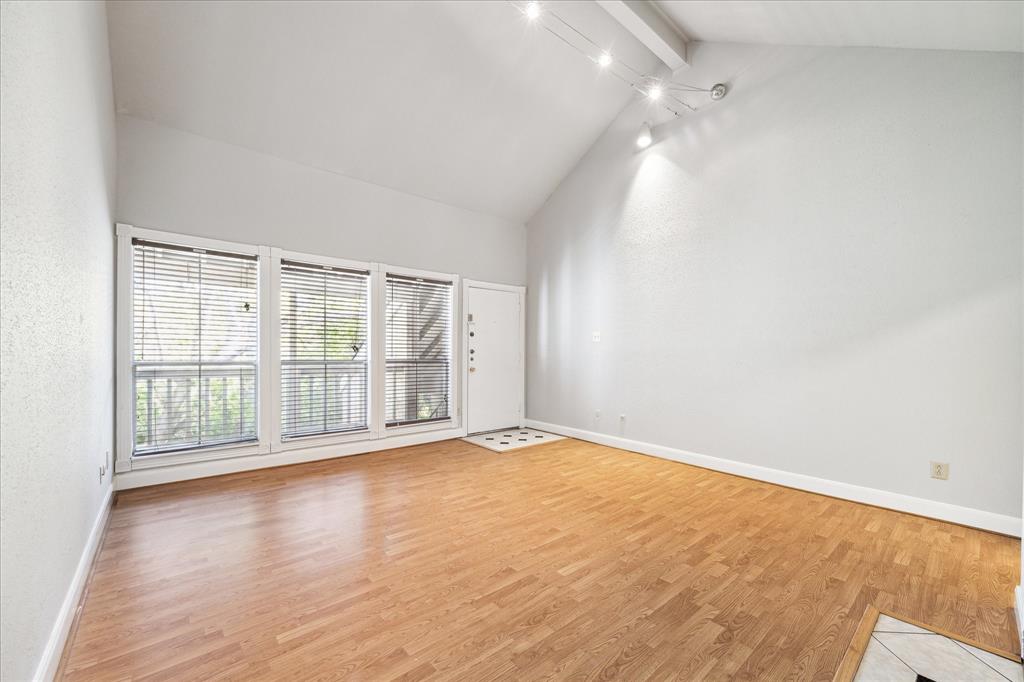 Natural Lighting Accents the Spacious Living Room with View to the Covered Balcony. Freshly Painted Throughout.All Flooring is Laminate and Tile.