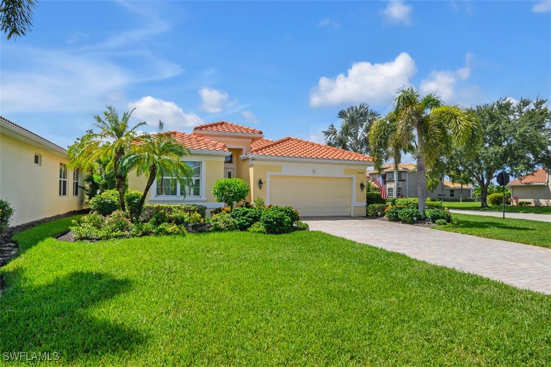 a front view of a house with a yard and potted plants