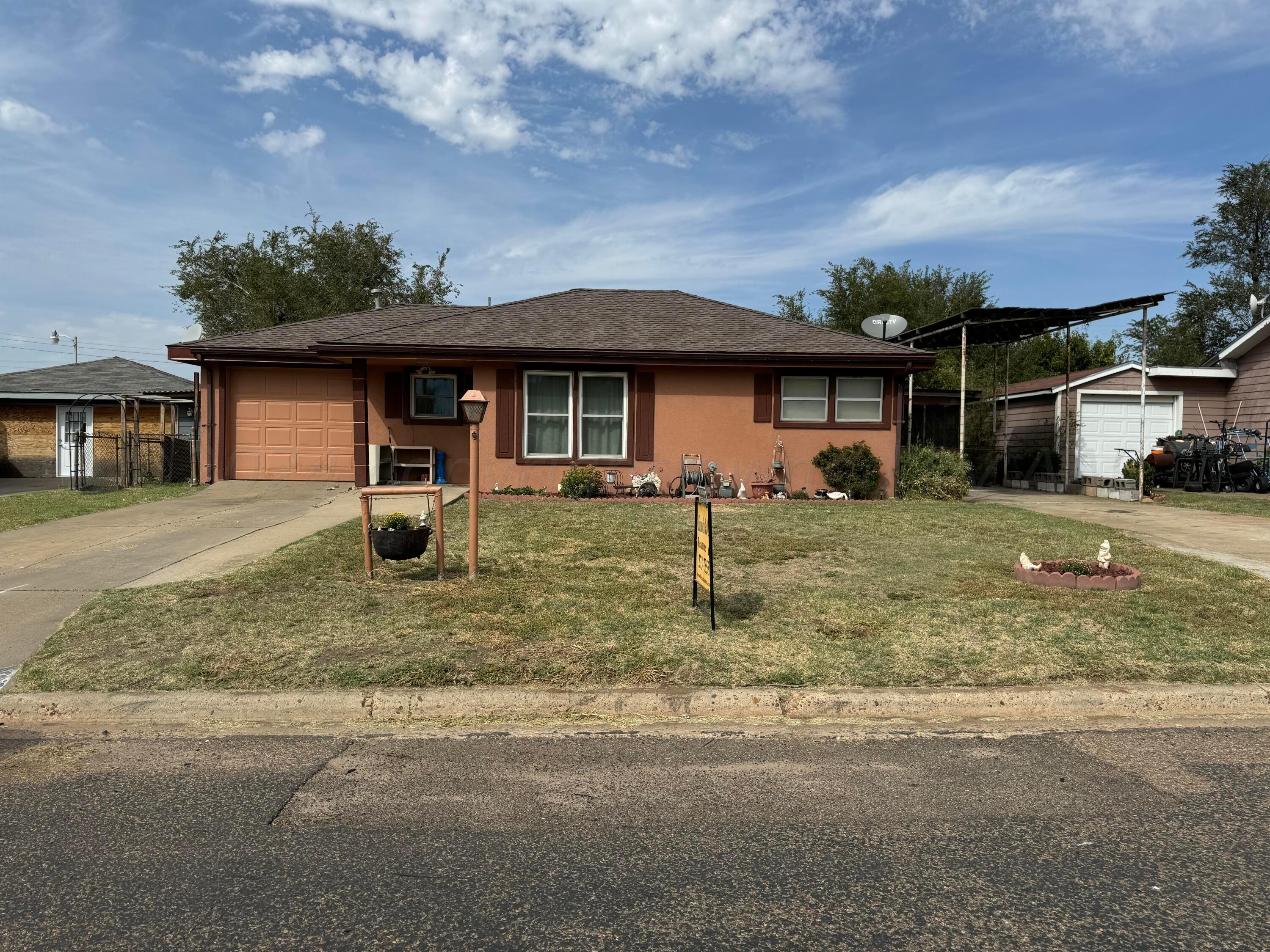 a front view of a house with a yard garage and outdoor seating