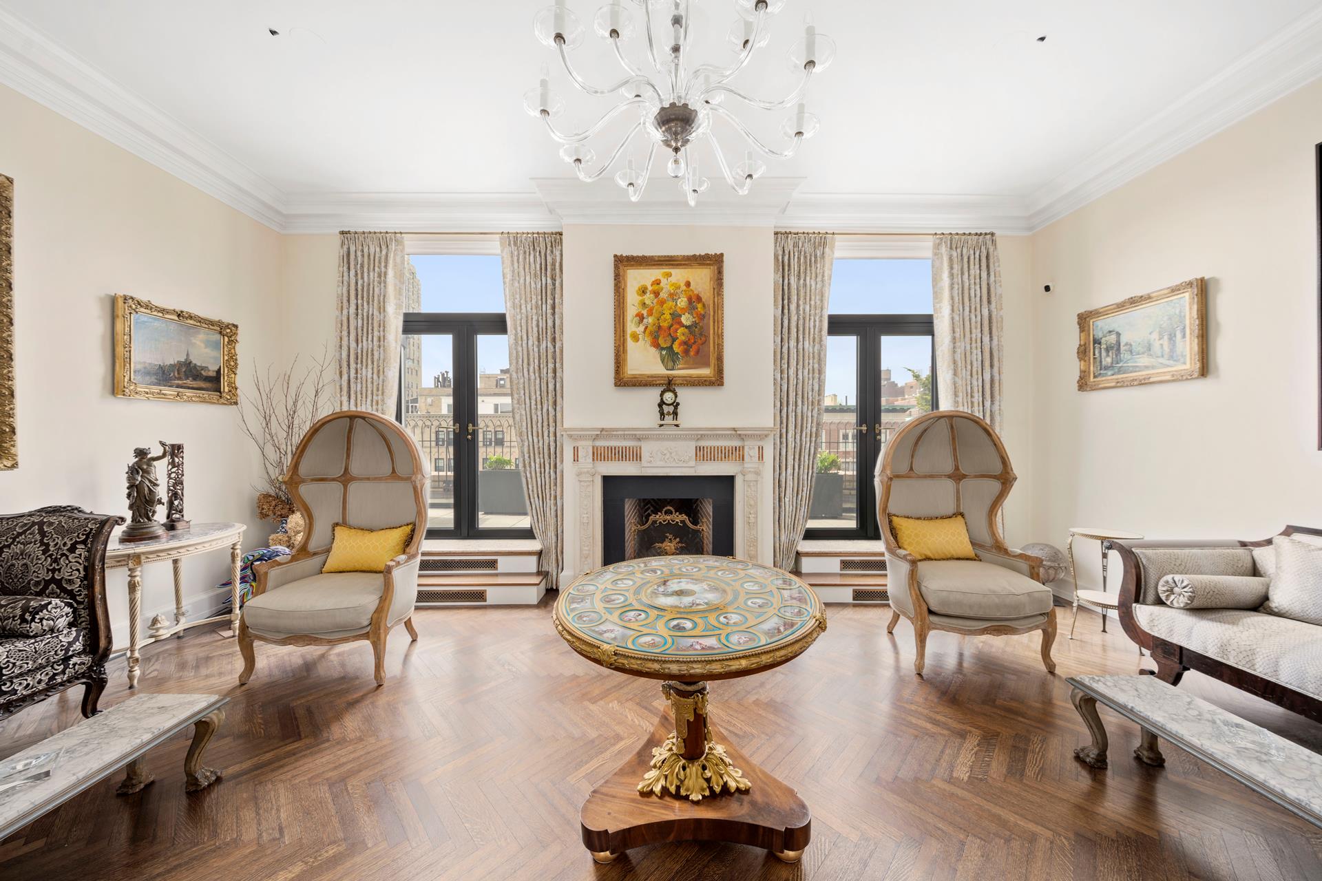 a living room with furniture and a chandelier