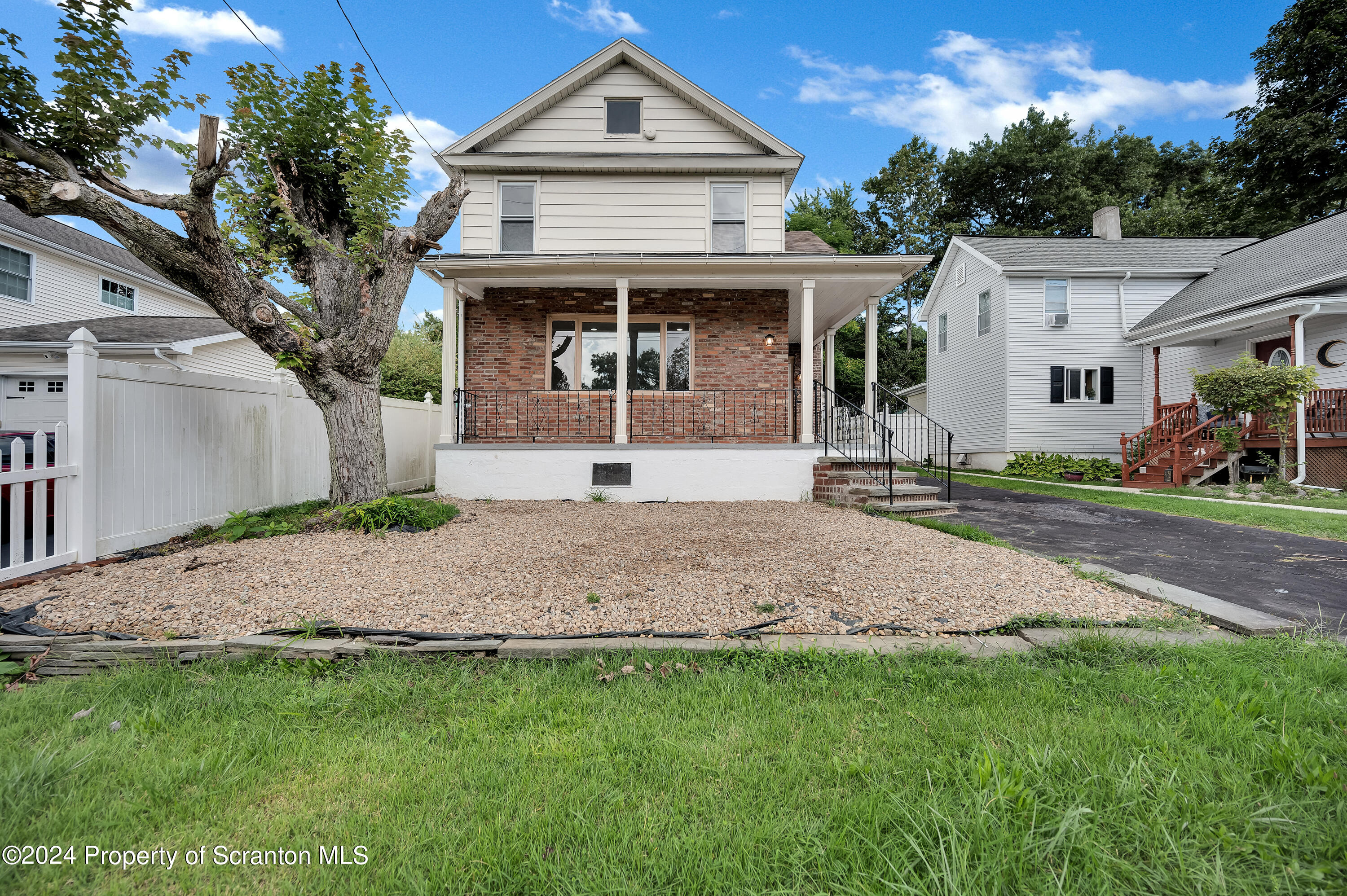 a front view of a house with a garden and yard