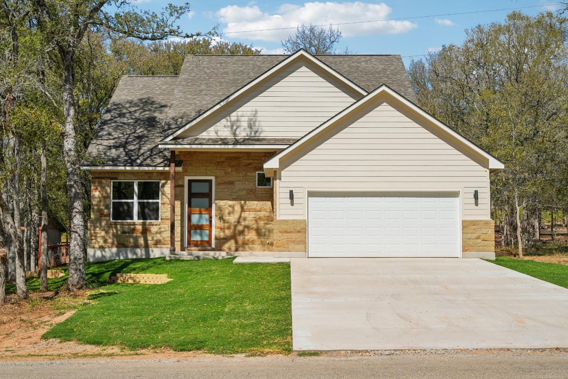 a view of a house with a yard and sitting area