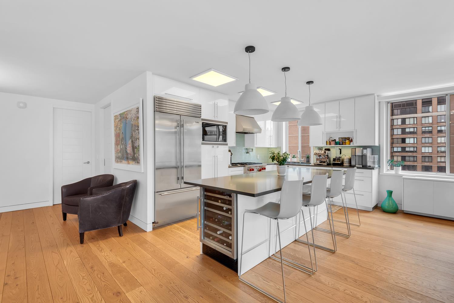 a kitchen with stainless steel appliances granite countertop a sink and a refrigerator