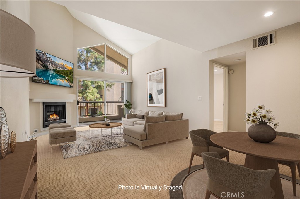 a living room with furniture potted plant and a fireplace